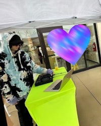 a man wearing a pair of ripped jeans with paint on them