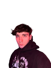 a young man in a white t - shirt standing in front of a purple background